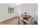Bright dining room with wood floors, a round table with seating for four, and a window at 9000 Bay Ne St, St Petersburg, FL 33702