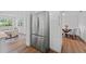 Hallway featuring stainless steel refrigerator, wood floors, and open sight lines to living and dining areas at 9000 Bay Ne St, St Petersburg, FL 33702