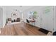 Bright living room featuring hardwood floors, ceiling fan, and neutral paint, with large windows allowing ample natural light at 9000 Bay Ne St, St Petersburg, FL 33702