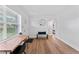 Bright living room featuring hardwood floors, ceiling fan, and neutral paint, with large windows allowing ample natural light at 9000 Bay Ne St, St Petersburg, FL 33702