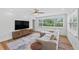 Bright living room with large TV, stylish furniture, and a view of the well-manicured backyard at 9000 Bay Ne St, St Petersburg, FL 33702
