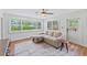 Sunlit living room featuring a comfortable sectional sofa and large windows overlooking a landscaped yard at 9000 Bay Ne St, St Petersburg, FL 33702