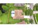 Aerial view of home showcasing a spacious backyard, screened pool, and well-manicured landscaping at 9813 Woodbay Dr, Tampa, FL 33626