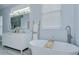Elegant bathroom featuring a soaking tub, double vanity, and modern fixtures at 9813 Woodbay Dr, Tampa, FL 33626