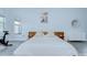 Bright bedroom featuring wood accent wall, modern decor and comfortable furnishings at 9813 Woodbay Dr, Tampa, FL 33626