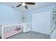 Inviting bedroom with a crib, comfortable chair, and warm lighting at 9813 Woodbay Dr, Tampa, FL 33626