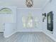 Light and airy bonus room featuring a decorative light fixture and wall mounted workout device at 9813 Woodbay Dr, Tampa, FL 33626