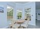 Cozy dining area featuring natural light and views of the screened pool at 9813 Woodbay Dr, Tampa, FL 33626