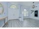 The foyer features wood-look flooring, large front doors and natural light at 9813 Woodbay Dr, Tampa, FL 33626