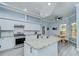 Open-concept kitchen featuring stainless steel appliances, granite countertops, breakfast nook, and modern white cabinetry at 9813 Woodbay Dr, Tampa, FL 33626