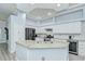 Modern kitchen showcasing a large island with granite countertops, stainless steel appliances, and ample cabinet space at 9813 Woodbay Dr, Tampa, FL 33626