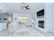 The open living room features a fireplace, access to the backyard and wood-look flooring at 9813 Woodbay Dr, Tampa, FL 33626