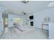 The bright living room features a fireplace, lots of light and wood-look flooring at 9813 Woodbay Dr, Tampa, FL 33626
