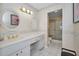 Bathroom vanity with double mirrors, white countertop and cabinets, adjacent to a glass enclosed shower at 100 Bluff View Dr # 511C, Belleair Bluffs, FL 33770