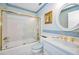 Classic bathroom with a shower-tub combo, white vanity, and charming decorative accents in a calming color palette at 100 Bluff View Dr # 511C, Belleair Bluffs, FL 33770