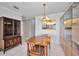 Dining area with wooden furniture, vintage cabinet, and window view into the kitchen, complemented by tile flooring at 100 Bluff View Dr # 511C, Belleair Bluffs, FL 33770