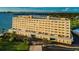 Stunning waterfront condo building, featuring covered parking and manicured landscaping at 100 Bluff View Dr # 511C, Belleair Bluffs, FL 33770