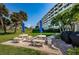 Community waterfront grounds with manicured green space, picnic tables, and waterfront view at 100 Bluff View Dr # 511C, Belleair Bluffs, FL 33770