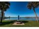 Community waterfront grounds with picnic tables, shade umbrellas, and serene water views at 100 Bluff View Dr # 511C, Belleair Bluffs, FL 33770