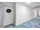 Condo hallway with door decorated with holiday wreath and neutral decor at 100 Bluff View Dr # 511C, Belleair Bluffs, FL 33770
