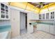 Kitchen space featuring white cabinets and countertops, along with an adjacent doorway and a window at 100 Bluff View Dr # 511C, Belleair Bluffs, FL 33770