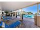 Inviting community pool area featuring lounge chairs and lush tropical landscaping in a resort setting at 100 Bluff View Dr # 511C, Belleair Bluffs, FL 33770