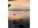 Sunset ocean view from the balcony, featuring sailboats and a waterfront at 100 Bluff View Dr # 511C, Belleair Bluffs, FL 33770