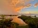 Gorgeous sunset reflecting off the water near a bridge and lush vegetation at 100 Bluff View Dr # 511C, Belleair Bluffs, FL 33770