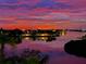 Sunset colors in the sky, waterfront view of homes on the opposite shore reflecting in the waterway at 100 Bluff View Dr # 511C, Belleair Bluffs, FL 33770