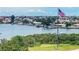 Waterfront view featuring calm waters and beautiful homes nestled among lush tropical trees at 100 Bluff View Dr # 511C, Belleair Bluffs, FL 33770