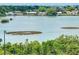 Scenic waterfront view featuring lush greenery and serene waterscapes with homes in the distance on a bright day at 100 Bluff View Dr # 511C, Belleair Bluffs, FL 33770