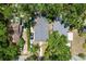 Aerial view of the property showcasing the house, driveway, and surrounding lush greenery in a suburban setting at 1019 E Mohawk Ave, Tampa, FL 33604