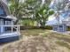 Lush backyard with a storage shed, fire pit, and a charming deck, ideal for outdoor entertaining at 1019 E Mohawk Ave, Tampa, FL 33604