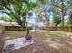 Spacious backyard featuring a fire pit, storage shed, and ample green space perfect for outdoor activities at 1019 E Mohawk Ave, Tampa, FL 33604