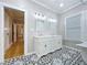 Elegant bathroom featuring a double vanity, decorative tile flooring, and a crystal chandelier at 1019 E Mohawk Ave, Tampa, FL 33604