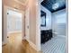 Stylish bathroom featuring a black vanity, patterned floor, and decorative lighting with a view into the next room at 1019 E Mohawk Ave, Tampa, FL 33604