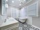 Luxurious bathroom showcasing a clawfoot tub, double vanity, designer tile floors, and ample natural light at 1019 E Mohawk Ave, Tampa, FL 33604