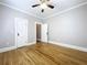 Bright bedroom features hardwood floors, neutral paint, and two doors on the back wall at 1019 E Mohawk Ave, Tampa, FL 33604