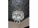 Elegant chandelier with crystal accents on a patterned ceiling, adding a touch of sophistication at 1019 E Mohawk Ave, Tampa, FL 33604