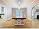 Well-lit dining room boasts beautiful hardwood floors, a farmhouse table, and seamless flow to adjacent rooms at 1019 E Mohawk Ave, Tampa, FL 33604