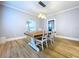 Bright dining room with hardwood floors, modern lighting, and a large wooden table with seating for four at 1019 E Mohawk Ave, Tampa, FL 33604