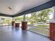 Inviting front porch with sturdy brick columns and decorative railings, offering a pleasant neighborhood view at 1019 E Mohawk Ave, Tampa, FL 33604