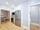 Kitchen showcases stainless steel appliances, including a refrigerator and wine cooler, with seamless access to laundry at 1019 E Mohawk Ave, Tampa, FL 33604