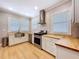 Bright kitchen featuring stainless steel appliances, butcher block countertops, and natural light from multiple windows at 1019 E Mohawk Ave, Tampa, FL 33604