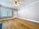 Bright and airy living room with polished hardwood floors and a modern ceiling fan, ready for personal touches at 1019 E Mohawk Ave, Tampa, FL 33604
