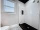 Bright bathroom featuring a walk-in shower with white subway tile and a black tiled floor at 1019 E Mohawk Ave, Tampa, FL 33604