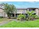 A charming condo with two stories, covered balconies, green grass, and mature trees, and the exterior has a neutral color palette at 10265 Gandy N Blvd # 1702, St Petersburg, FL 33702