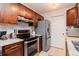 Modern kitchen with stainless steel appliances, granite countertops, and dark wood cabinets offering ample storage space at 10265 Gandy N Blvd # 1702, St Petersburg, FL 33702