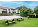 Community recreation area featuring picnic tables, a grill, and sand volleyball at 10265 Gandy N Blvd # 1702, St Petersburg, FL 33702