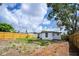 A spacious back yard featuring a wood fence and grassy area is ideal for outdoor activities and relaxation at 10408 118Th Ave, Largo, FL 33773